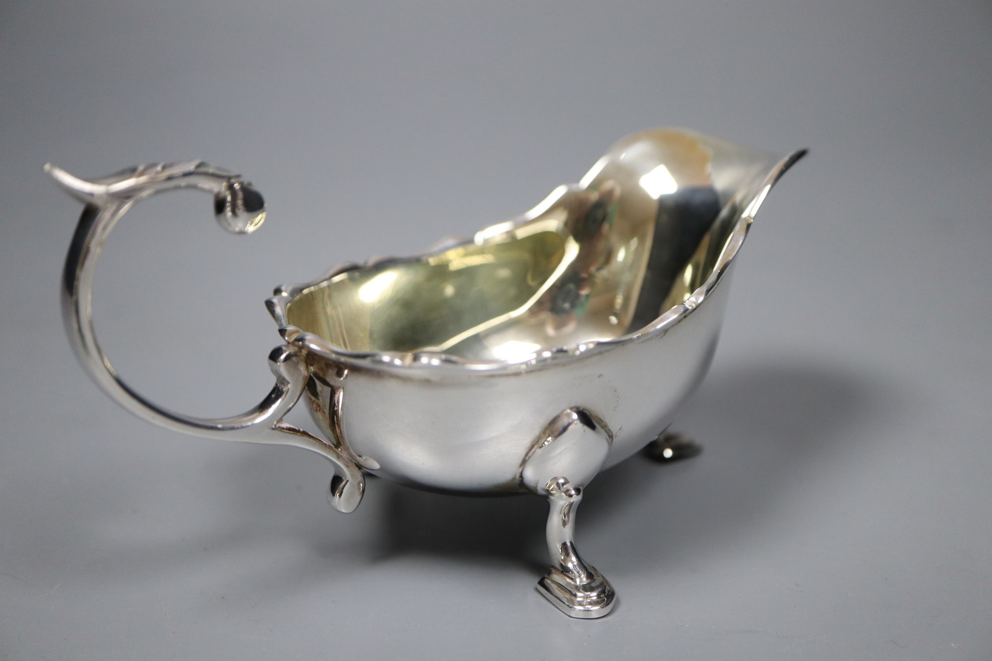 A pair of 1930s silver sauceboats, 5.5 oz and a plated sauceboat.